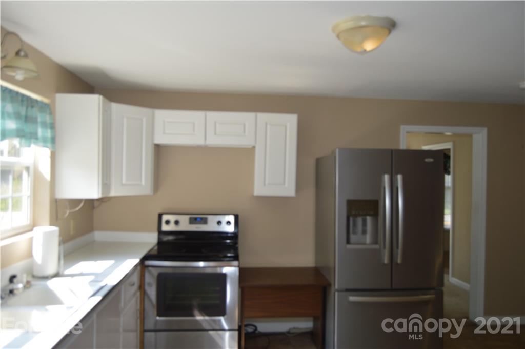 10835 Cool Springs Road Woodleaf, NC 27054 - Photo 10 of 35 a kitchen with stainless steel appliances granite countertop a refrigerator and a stove