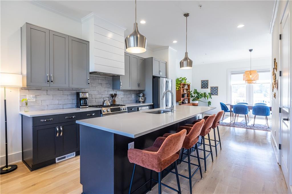 812 West College Avenue Decatur, GA 30030 - Photo 2 of 32 a kitchen with a dining table chairs stainless steel appliances and cabinets