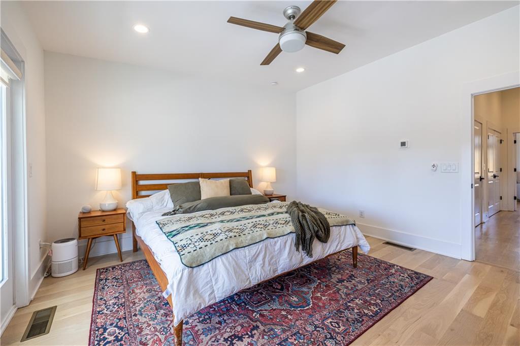 812 West College Avenue Decatur, GA 30030 - Photo 22 of 32 a bedroom with a bed and wooden floor