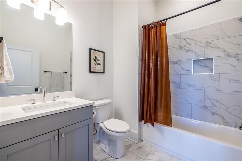 812 West College Avenue Decatur, GA 30030 - Photo 30 of 32 a bathroom with a sink a toilet and shower
