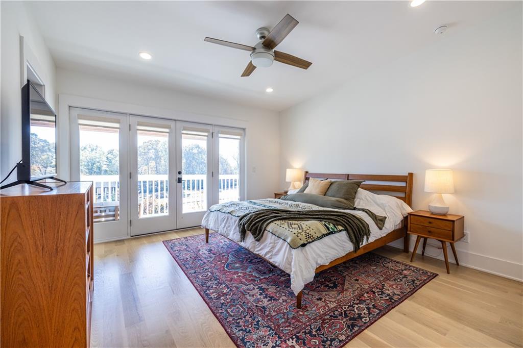 812 West College Avenue Decatur, GA 30030 - Photo 4 of 32 a bedroom with a bed a couch and a large window with wooden floor