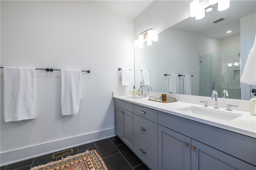 812 West College Avenue Decatur, GA 30030 - Photo 5 of 32 a bathroom with a double vanity sink a mirror and shower