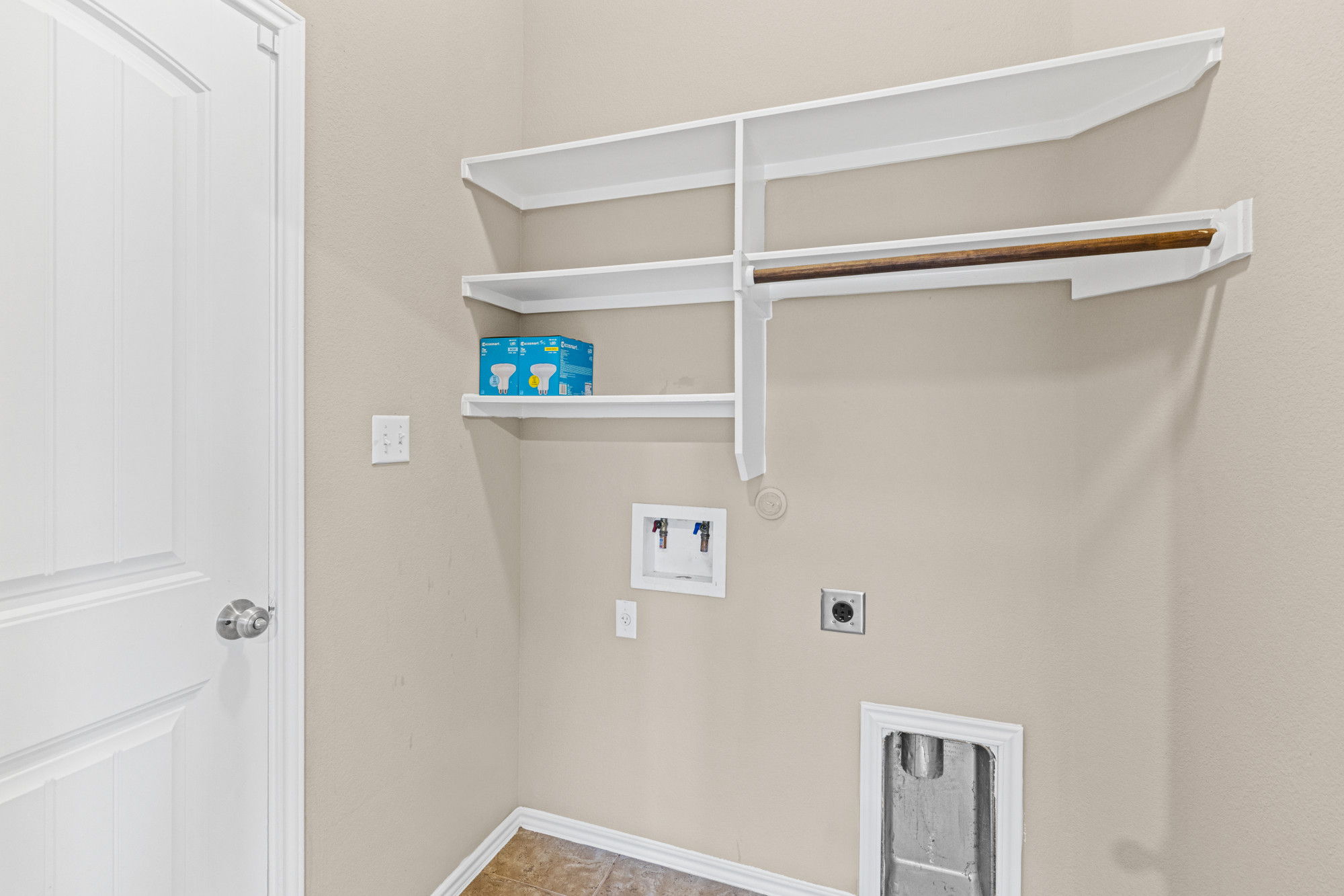 19308 Stokes Lane Pflugerville, TX 78660 - Photo 21 of 27 Dedicated laundry area featuring built-in shelving, a hanging rod, and utility hookups for appliances