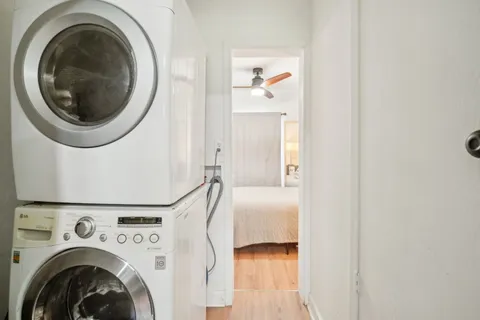 a view of a bedroom with washer and dryer