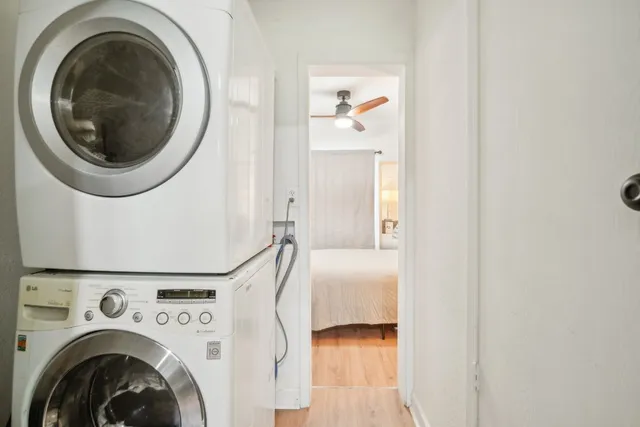a view of a bedroom with washer and dryer