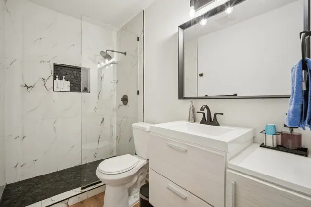 a bathroom with a sink toilet and shower
