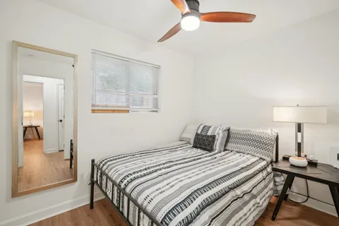 a bedroom with a bed and a mirror