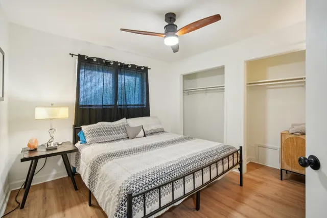 a bedroom with a bed and a chandelier