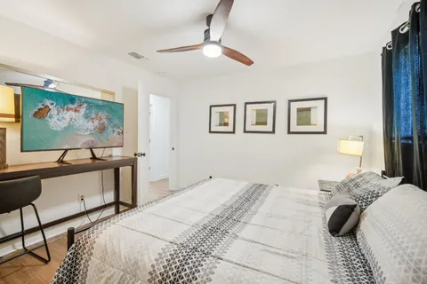 a bedroom with a bed and a flat screen tv