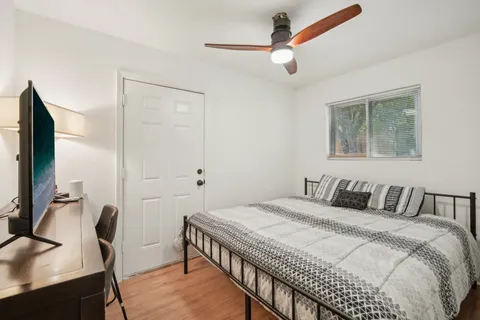 a bedroom with a bed a desk and chair