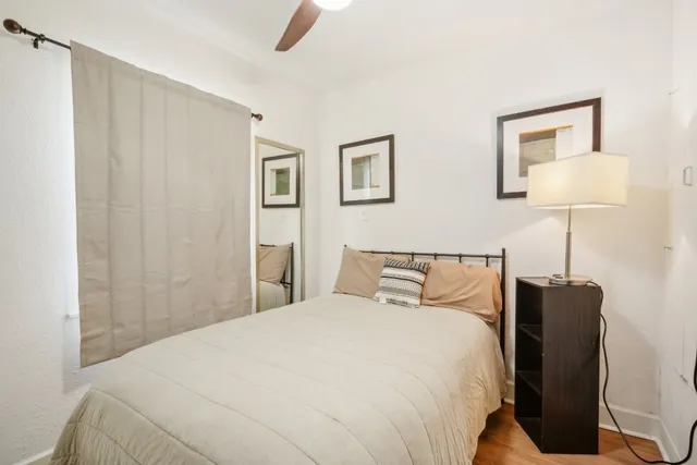 a bedroom with a bed and a lamp