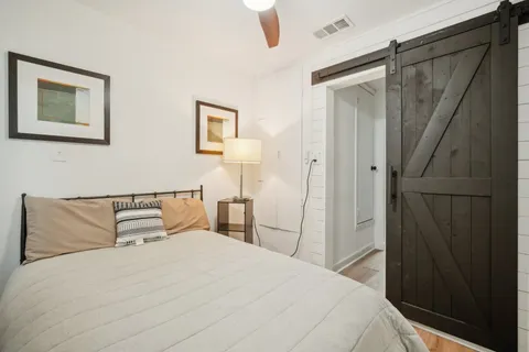 a bedroom with a bed and a mirror