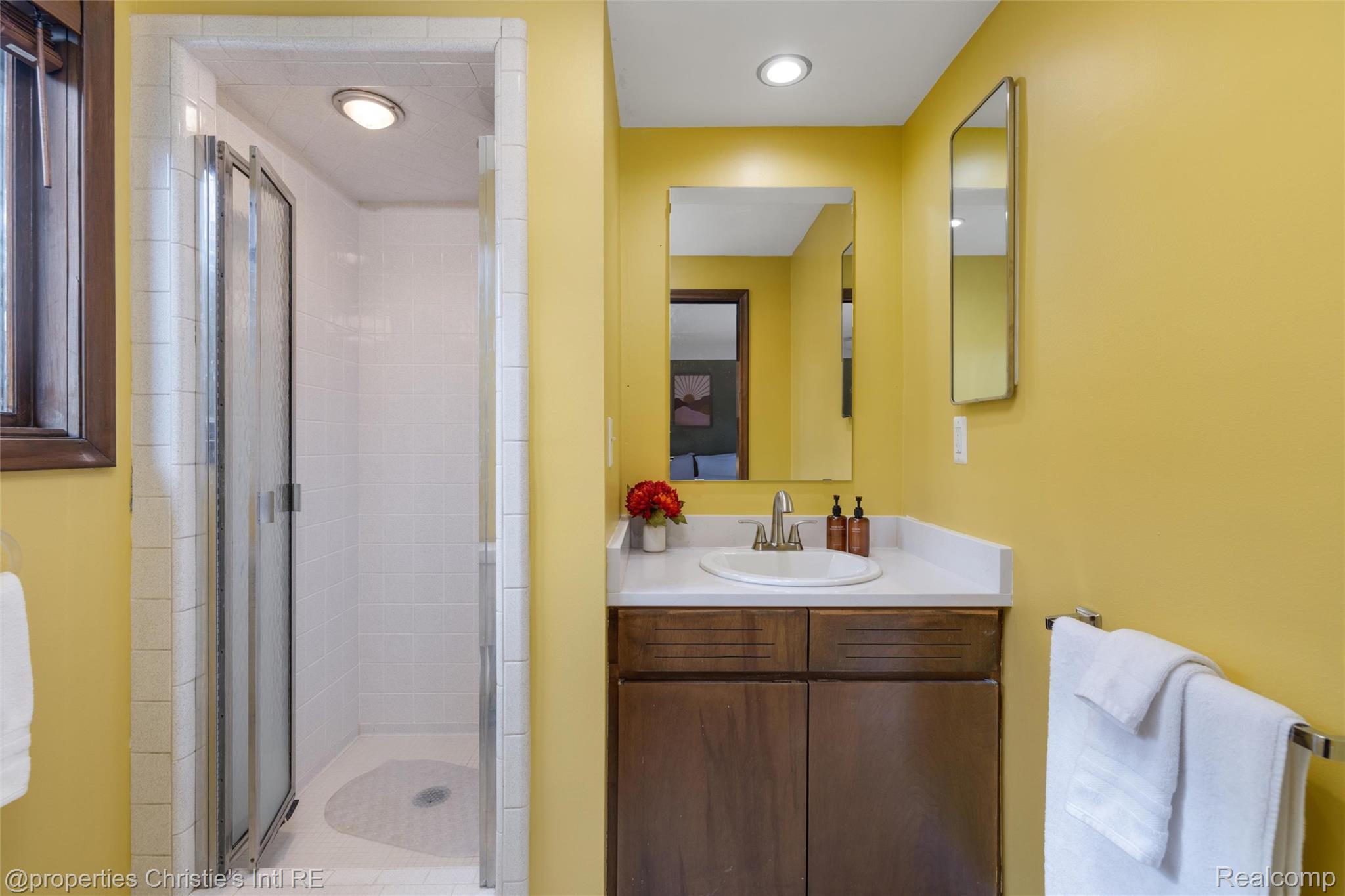 2771 West Seven Mile Road Detroit, MI 48221 - Photo 44 of 57 Bathroom featuring a single vanity with wood-finish cabinetry, a white countertop, and an undermount sink