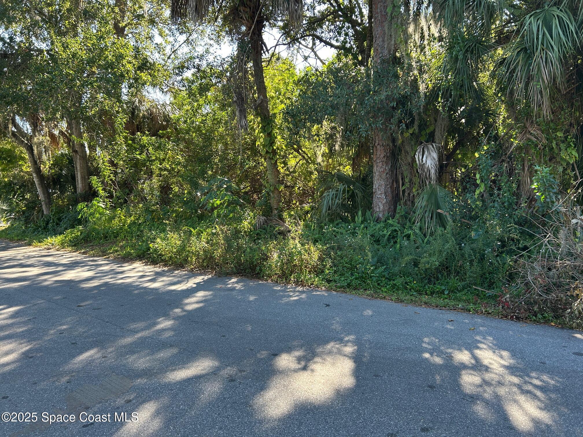 2845 Sunset Road Melbourne, FL 32904 - Photo 3 of 13 a view of a street with a trees