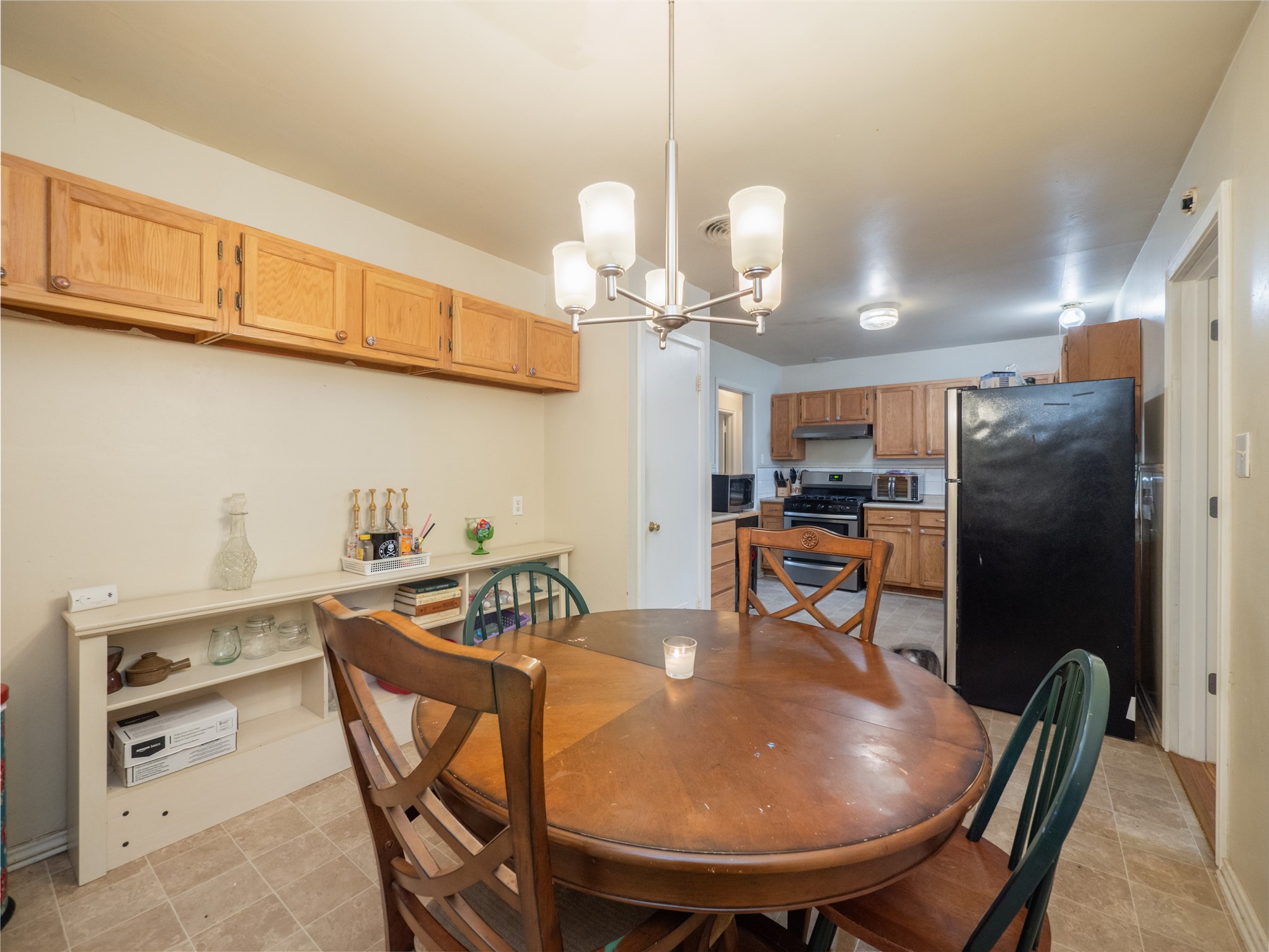 1910 South 13th Street Temple, TX 76504 - Photo 12 of 35 a dining room filled chandelier and kitchen view