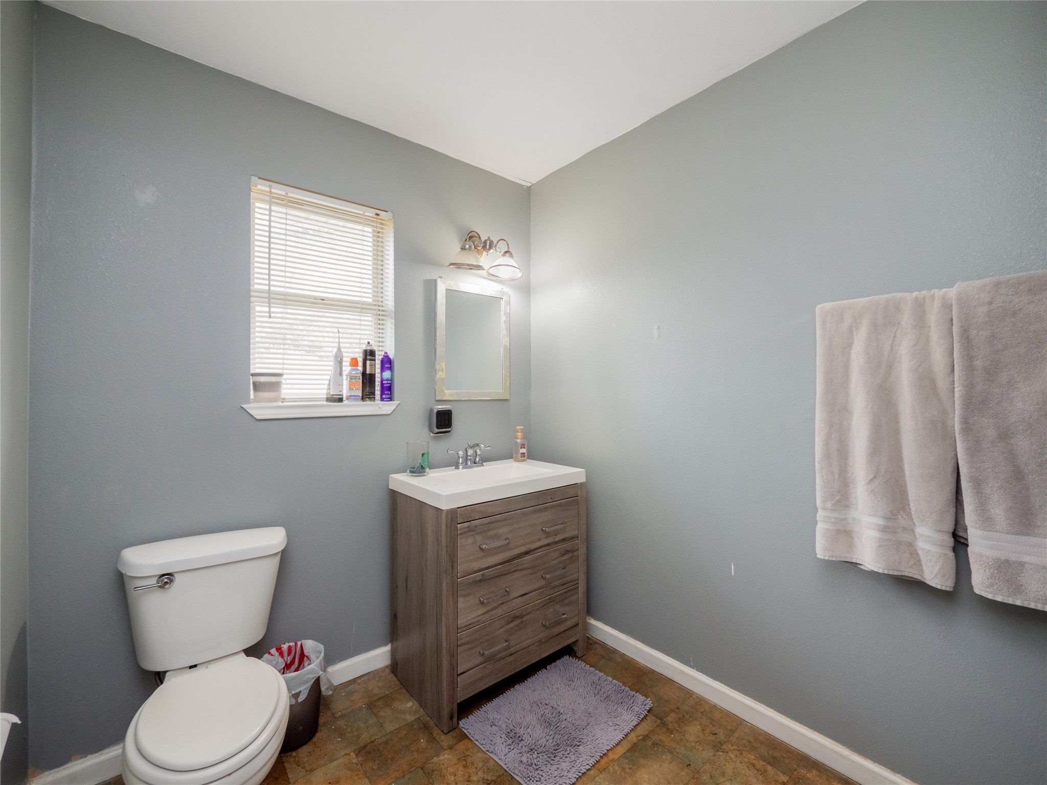 1910 South 13th Street Temple, TX 76504 - Photo 15 of 35 a bathroom with a toilet sink and mirror