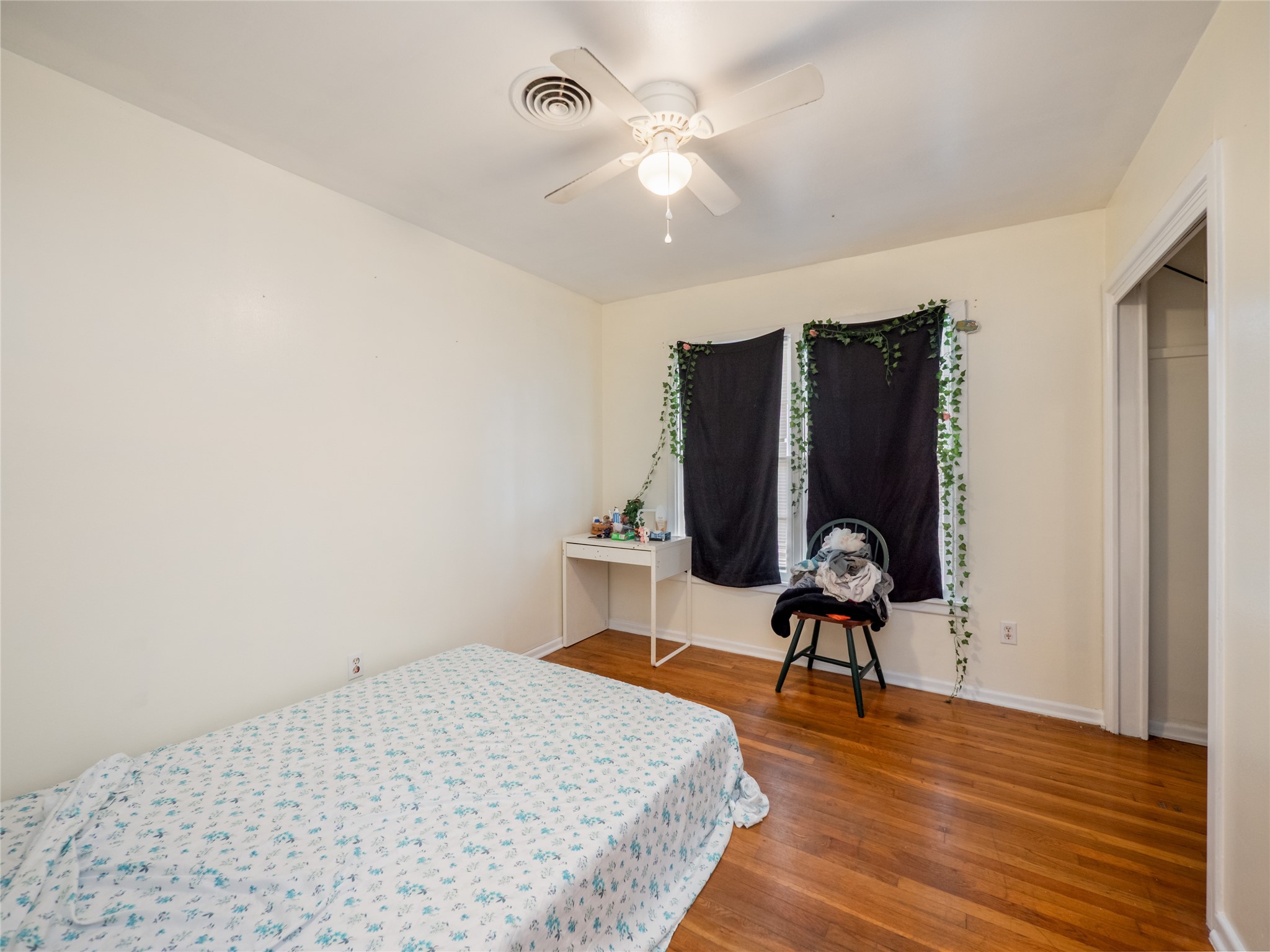 1910 South 13th Street Temple, TX 76504 - Photo 17 of 35 a bedroom with a bed and a chandelier