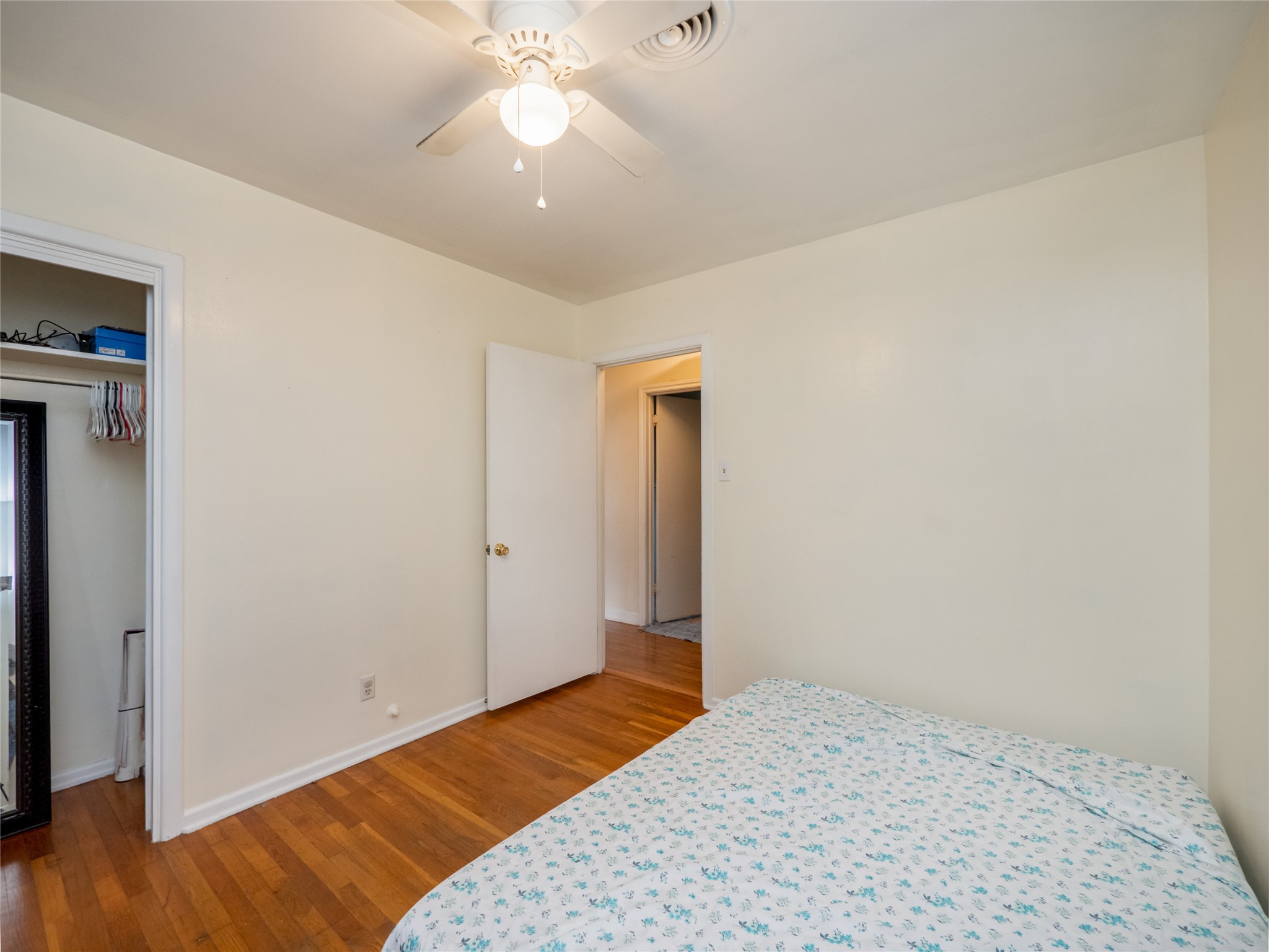 1910 South 13th Street Temple, TX 76504 - Photo 18 of 35 a bedroom with a bed and a chandelier fan