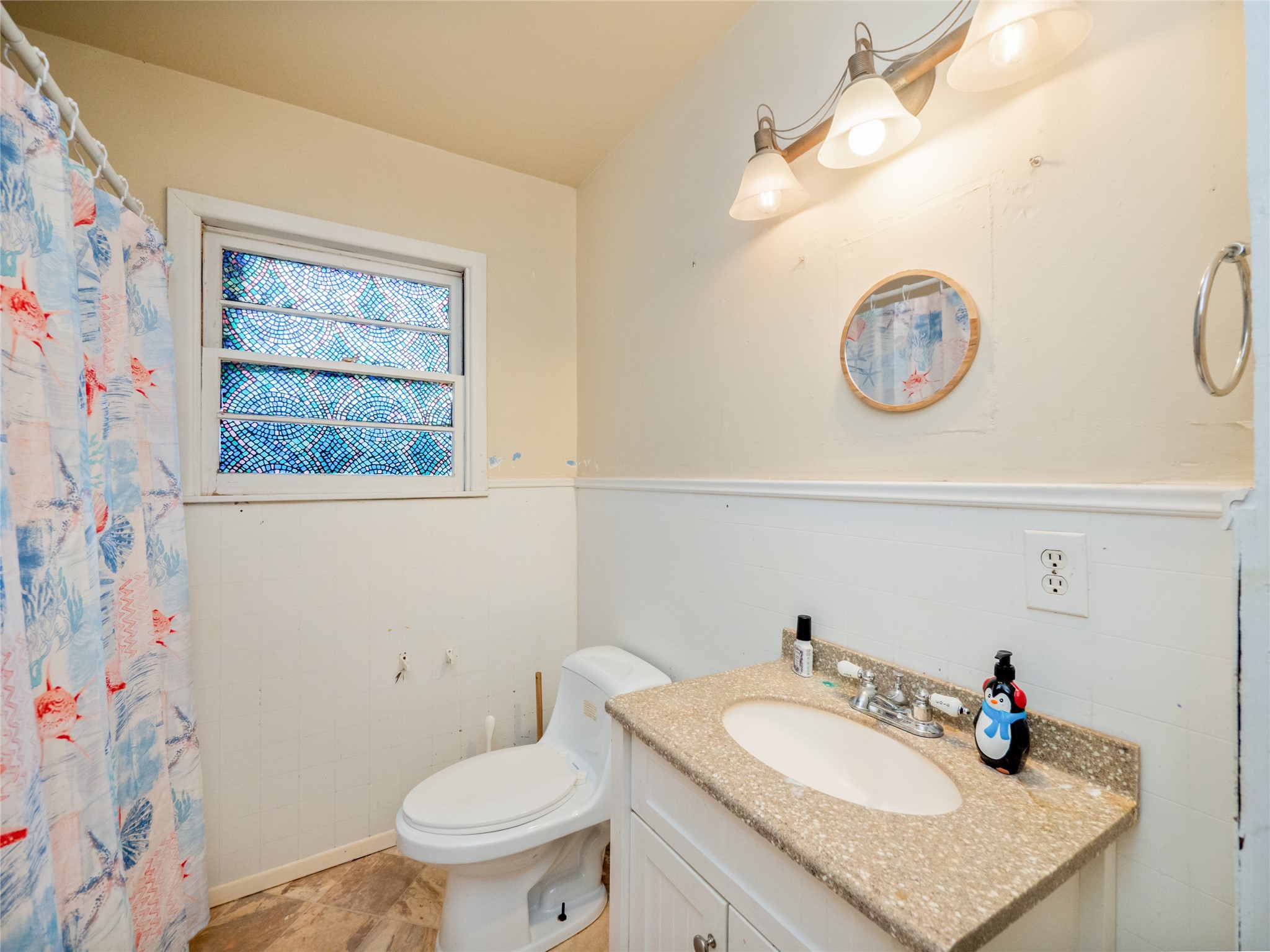 1910 South 13th Street Temple, TX 76504 - Photo 19 of 35 a bathroom with a sink vanity mirror and toilet