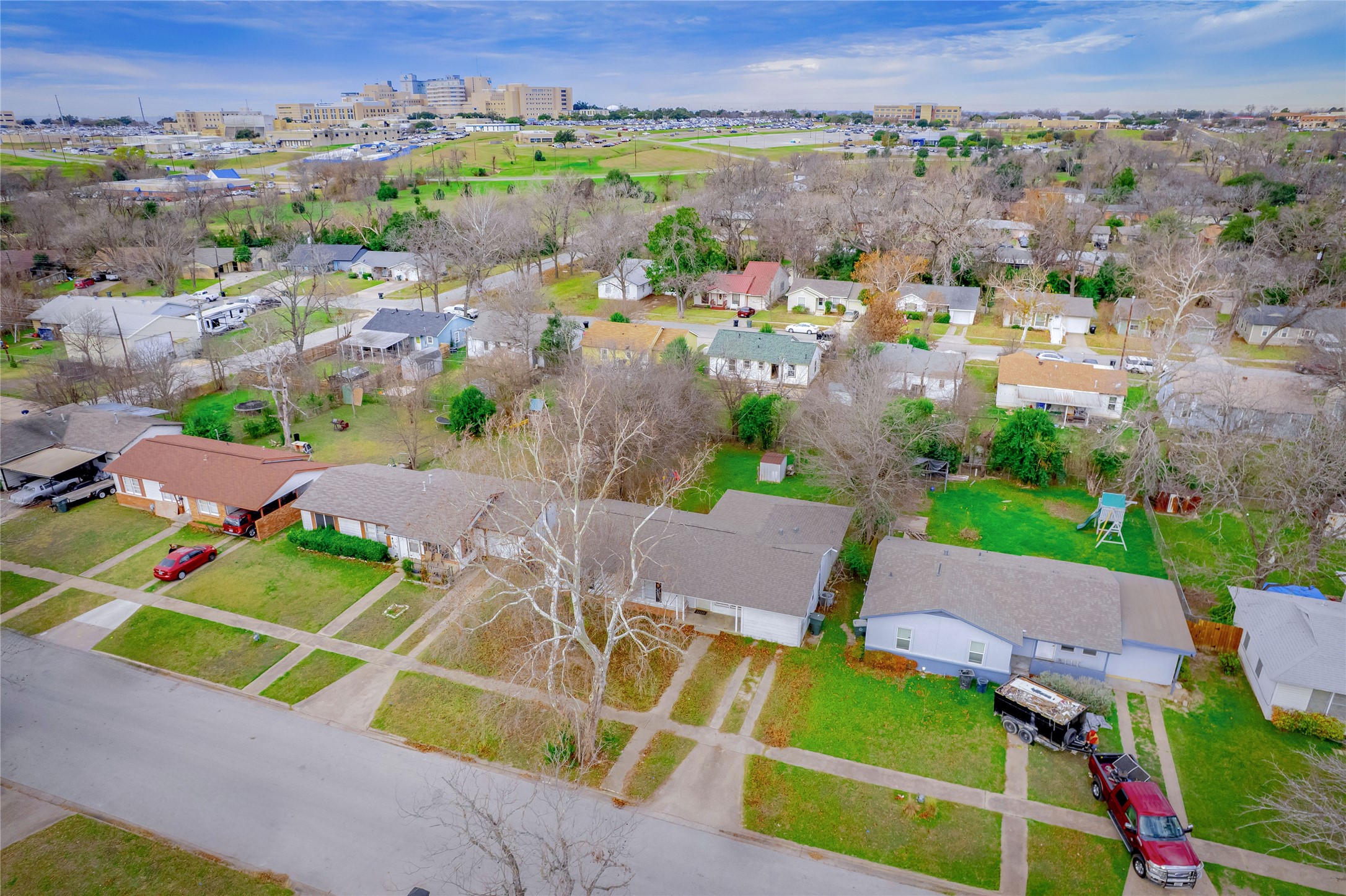 1910 South 13th Street Temple, TX 76504 - Photo 2 of 35 an aerial view of a house with a garden and lots of trees