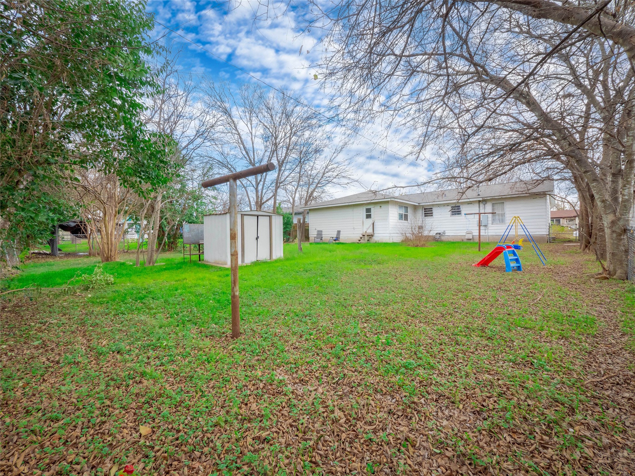 1910 South 13th Street Temple, TX 76504 - Photo 32 of 35 a view of a house with a backyard and a tree