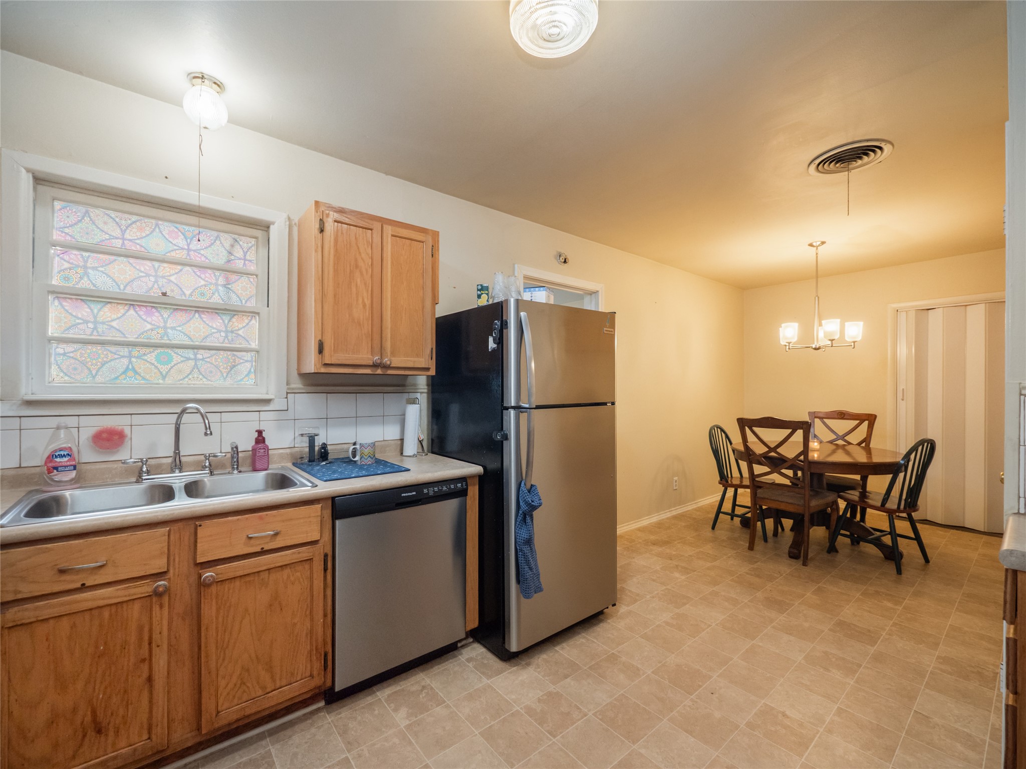 1910 South 13th Street Temple, TX 76504 - Photo 10 of 35 a kitchen with a sink a table and chairs in it