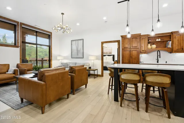 a living room with furniture and a chandelier