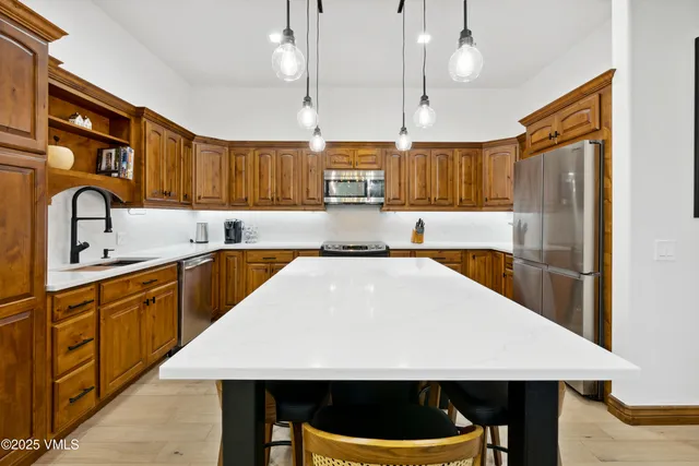 a bathroom with a tub a double vanity sink and a large mirror