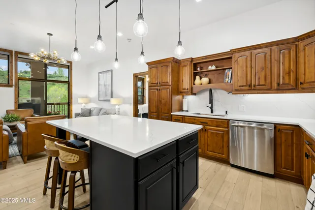 a bathroom with a granite countertop sink a potted plant and a shower