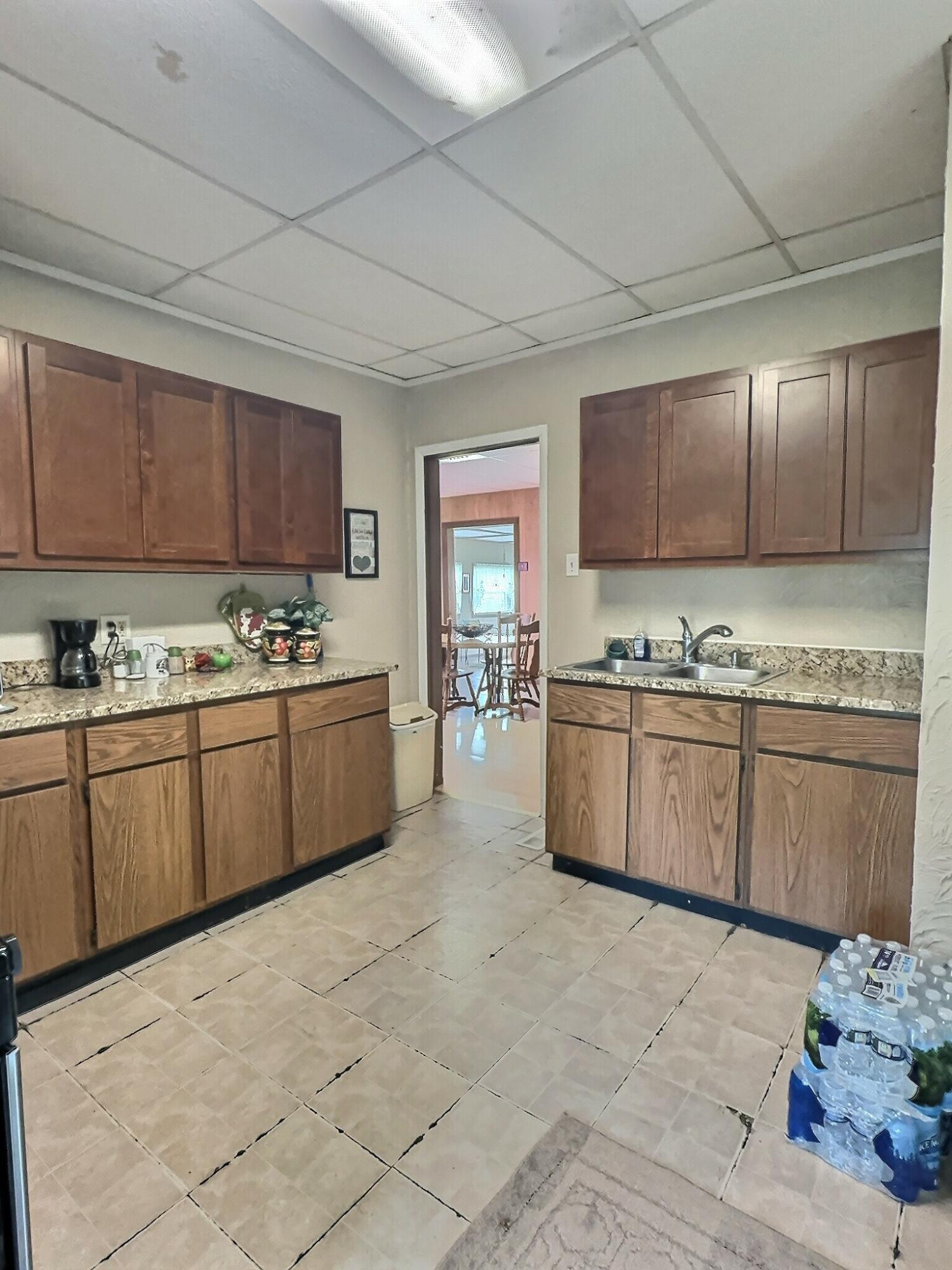 310 West State Street Morocco, IN 47963 - Photo 12 of 17 a kitchen with stainless steel appliances kitchen island granite countertop a sink a stove cabinets and a counter top space