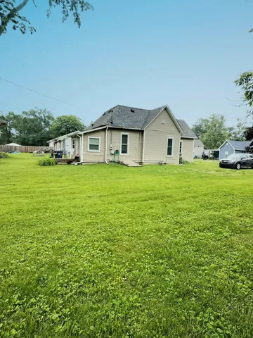 a big house with a big yard and large trees