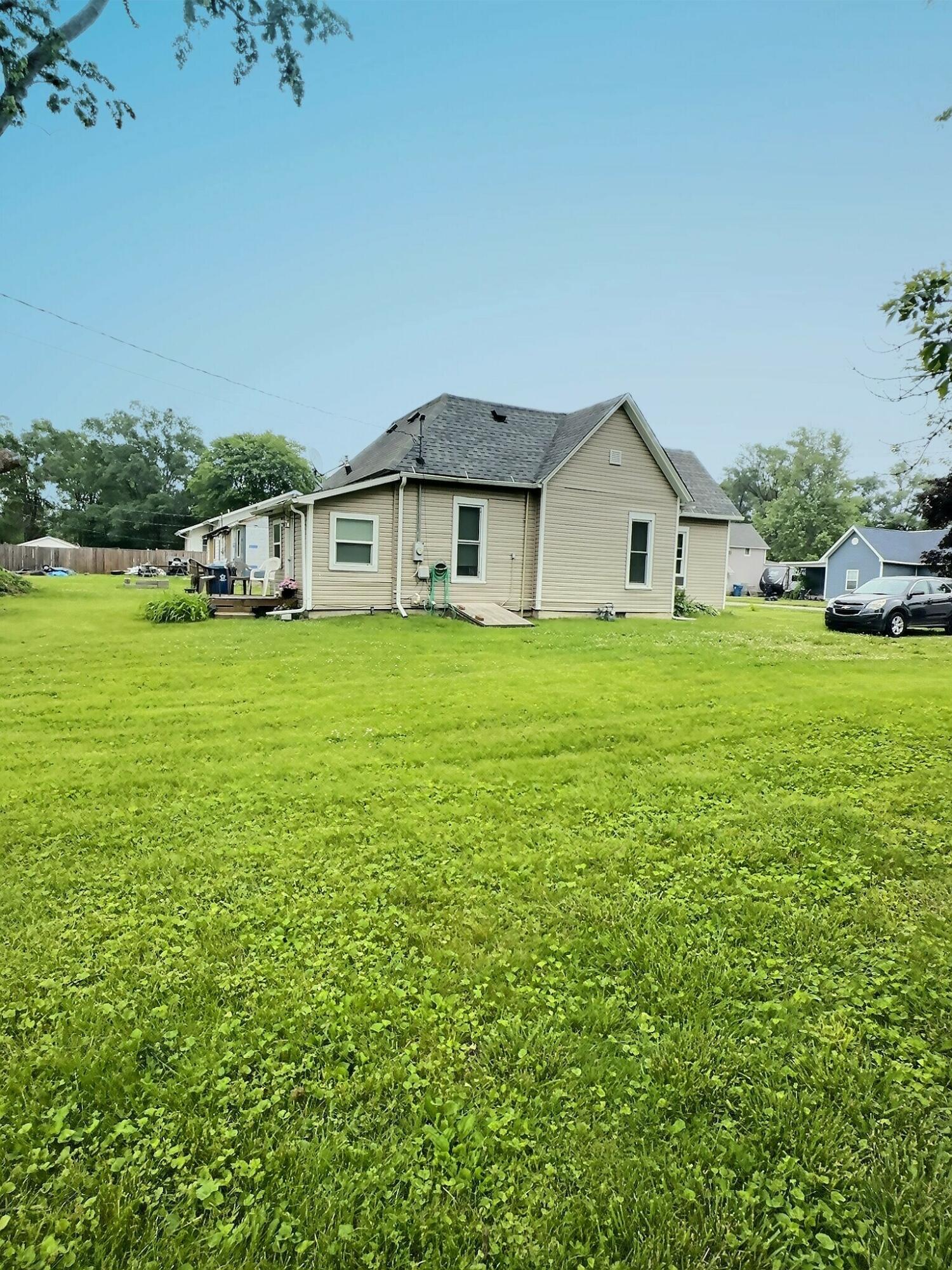 310 West State Street Morocco, IN 47963 - Photo 3 of 17 a big house with a big yard and large trees