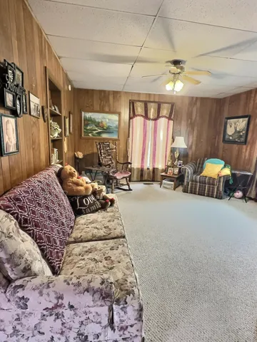 a bedroom with furniture and a large window