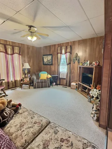 a bedroom with furniture and a flat screen tv