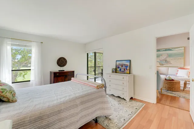 a view of a bedroom with furniture and window