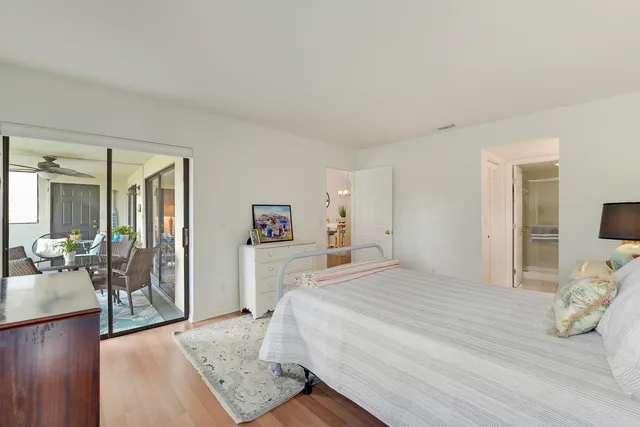 a bedroom with a bed and glass door