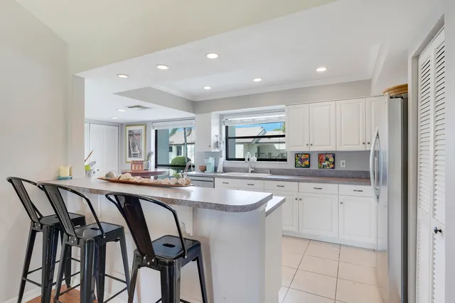 a kitchen with sink table and chairs