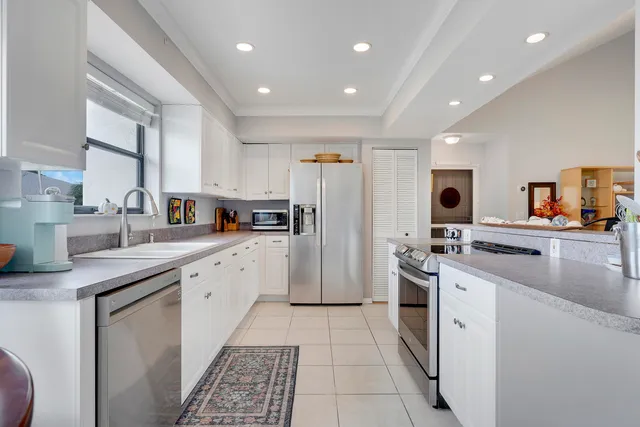 a kitchen with stainless steel appliances granite countertop a refrigerator sink and cabinets