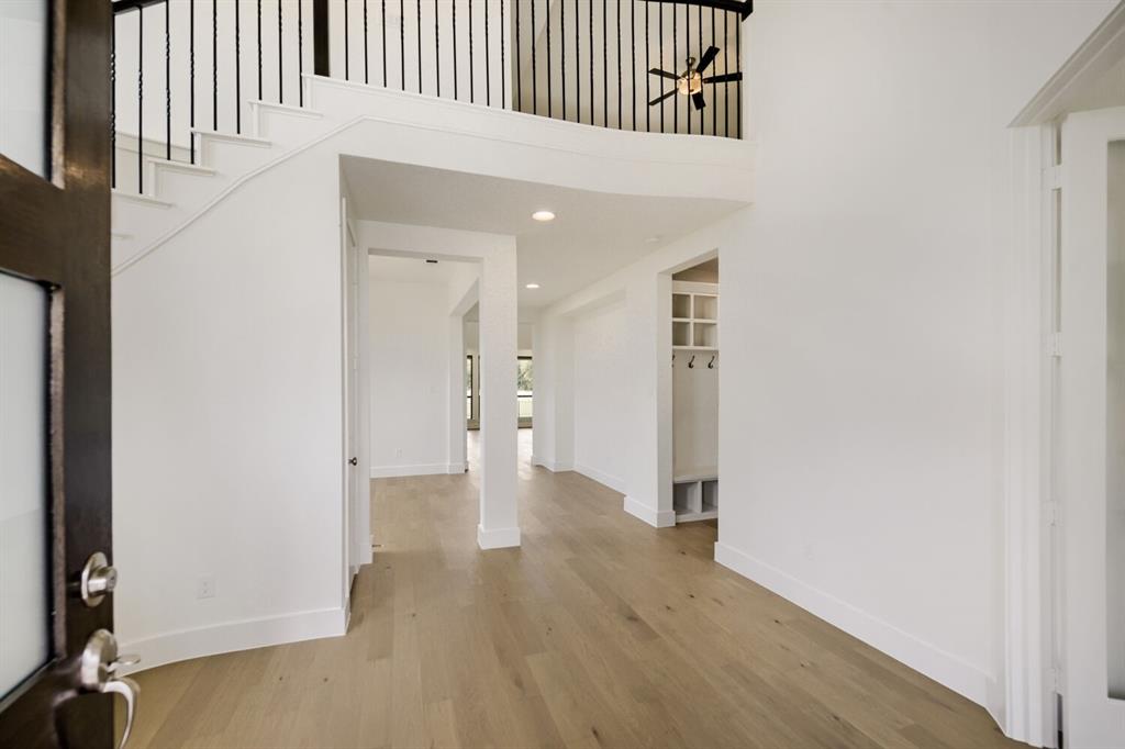 11465 Wulstone Road Fort Worth, TX 76052 - Photo 2 of 27 Spacious foyer with light wood-finish flooring and white baseboards