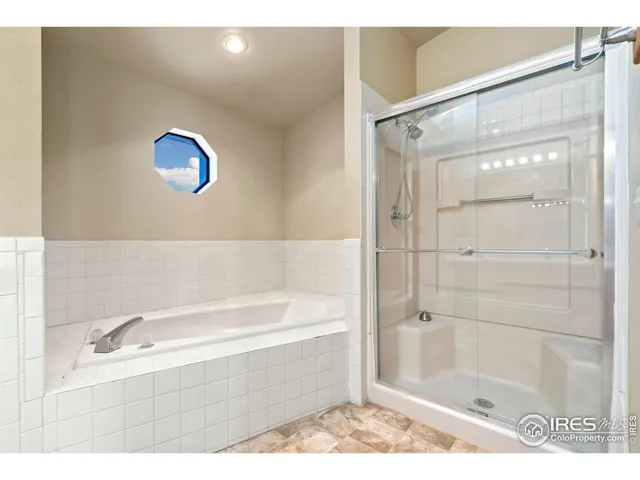 a bathroom with a bathtub and a shower