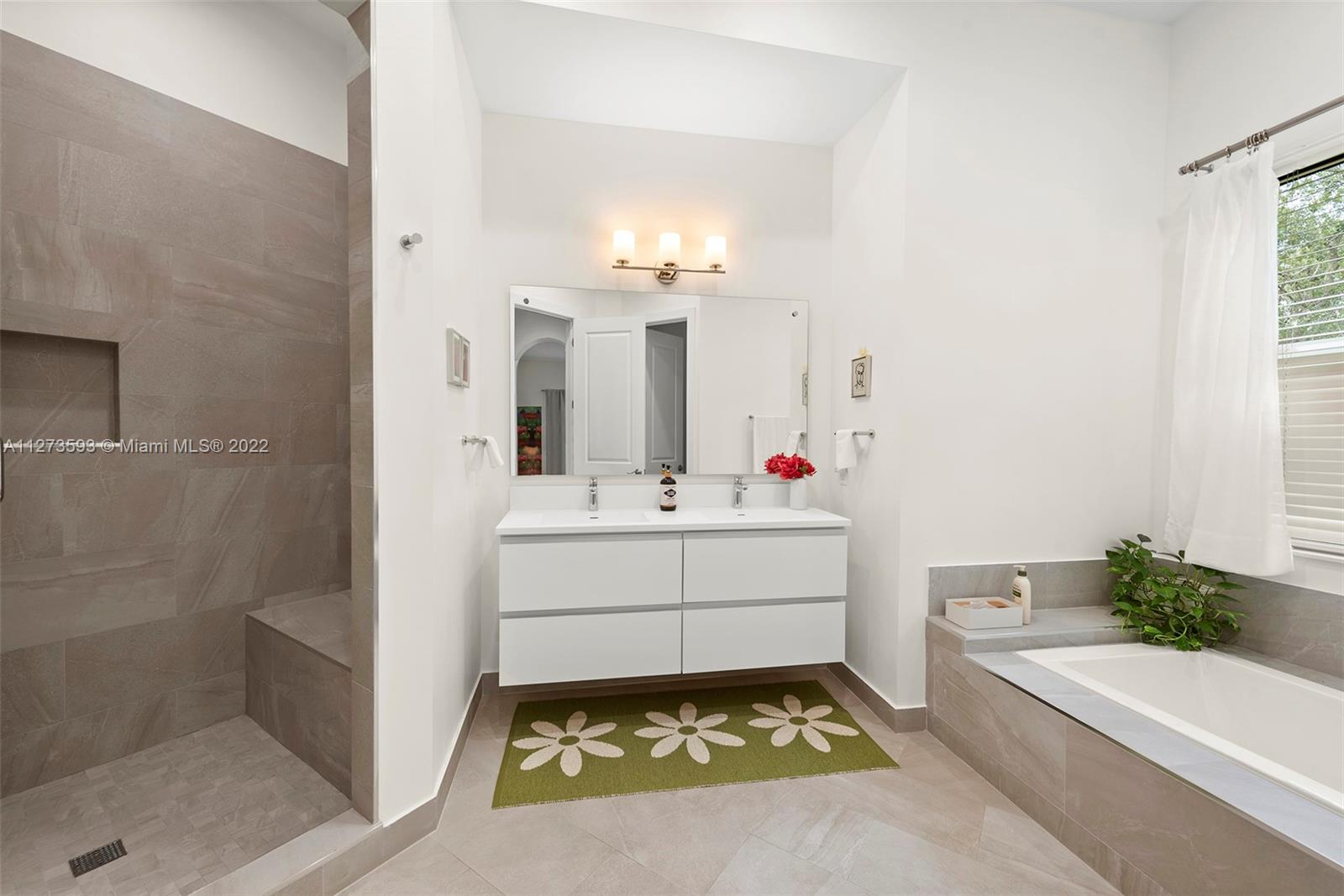 11411 Smathers Circle Pinecrest, FL 33156 - Photo 19 of 44 a bathroom with a sink and a mirror