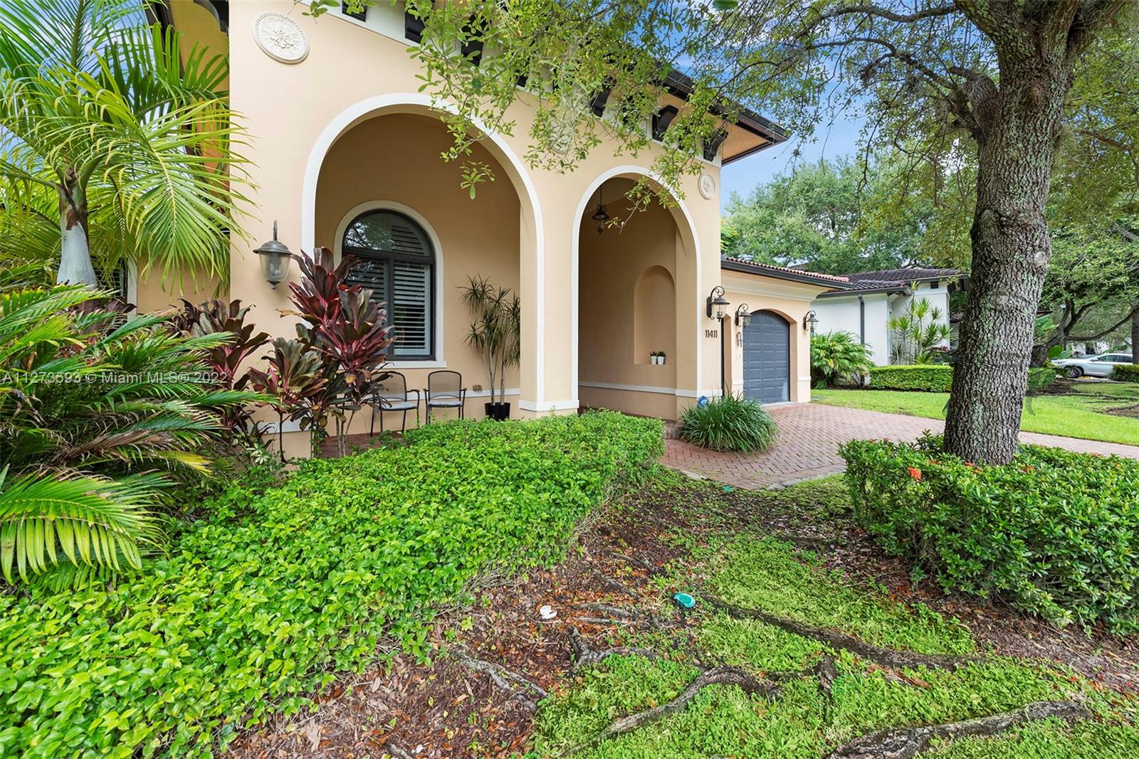 11411 Smathers Circle Pinecrest, FL 33156 - Photo 33 of 44 a front view of a house with garden