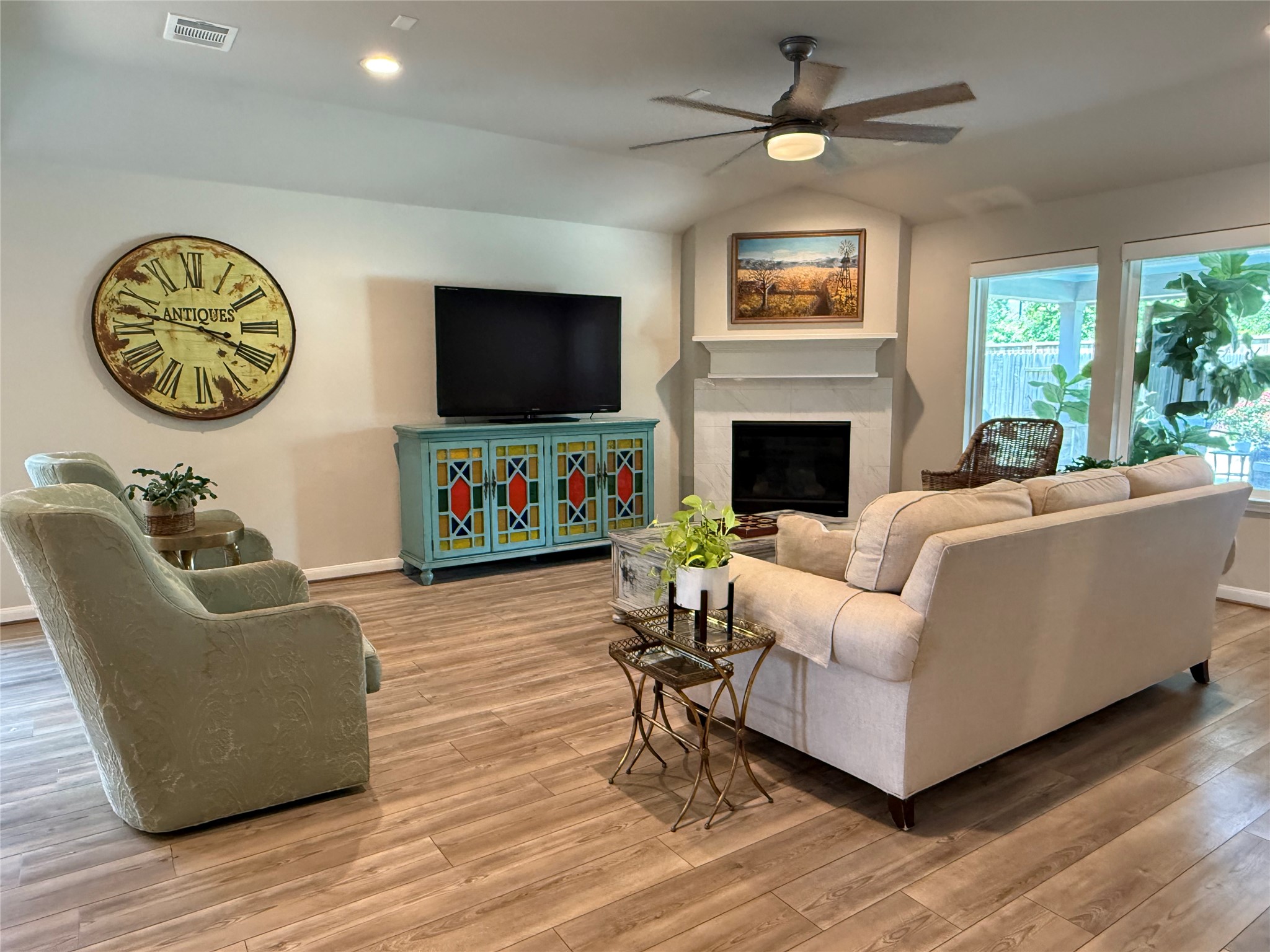 2336 Hagerman Road Conroe, TX 77384 - Photo 25 of 35 a living room with furniture a fireplace and a flat screen tv