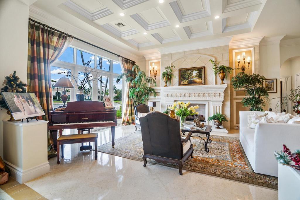 17542 Grand Este Way Boca Raton, FL 33496 - Photo 12 of 45 a living room with furniture a fireplace and a table