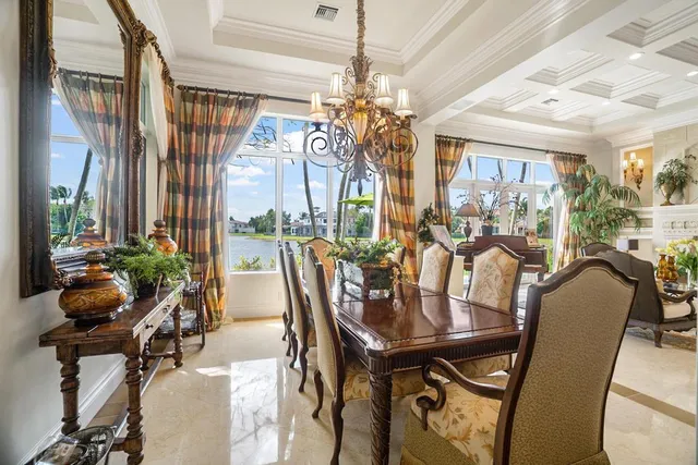 a living room with furniture a rug and a chandelier