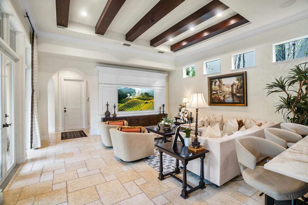 17542 Grand Este Way Boca Raton, FL 33496 - Photo 16 of 45 a living room with furniture a rug and a chandelier