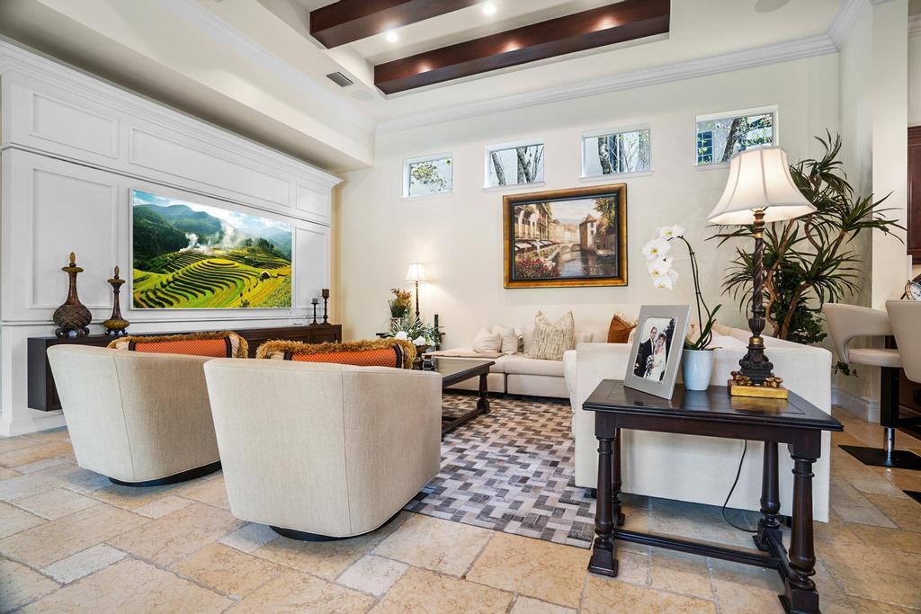 17542 Grand Este Way Boca Raton, FL 33496 - Photo 18 of 45 a living room with couches a coffee table and a large window with garden view