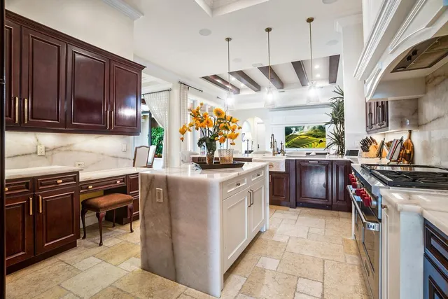 a kitchen with stainless steel appliances granite countertop a stove and a sink