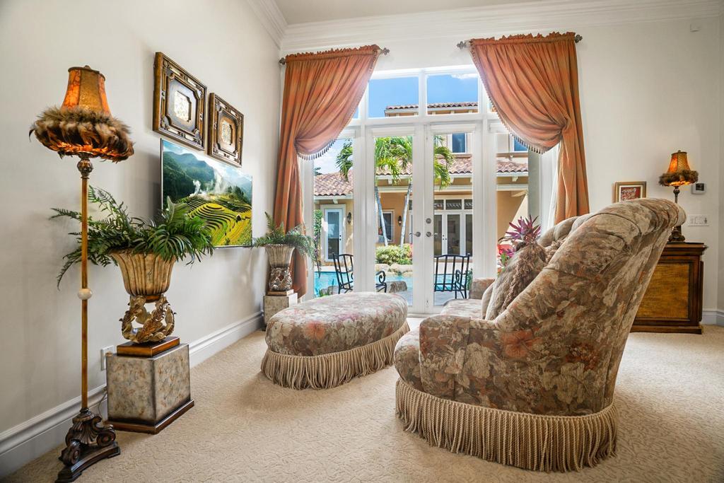 17542 Grand Este Way Boca Raton, FL 33496 - Photo 27 of 45 a living room with furniture a chandelier and a large window