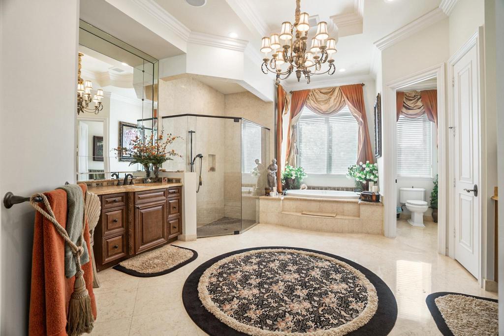 17542 Grand Este Way Boca Raton, FL 33496 - Photo 32 of 45 a bathroom with a sink a mirror and a shower